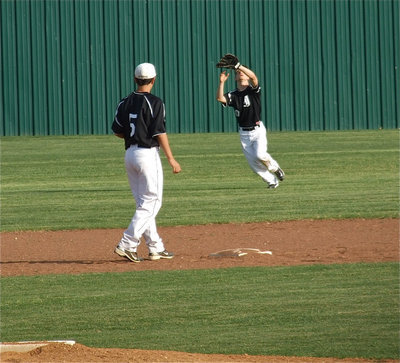 Image: Chase makes catch — JV shorstop Reid Jacinto(5) observes teammate, Chase Hamilton(10), make a catch in centerfield.