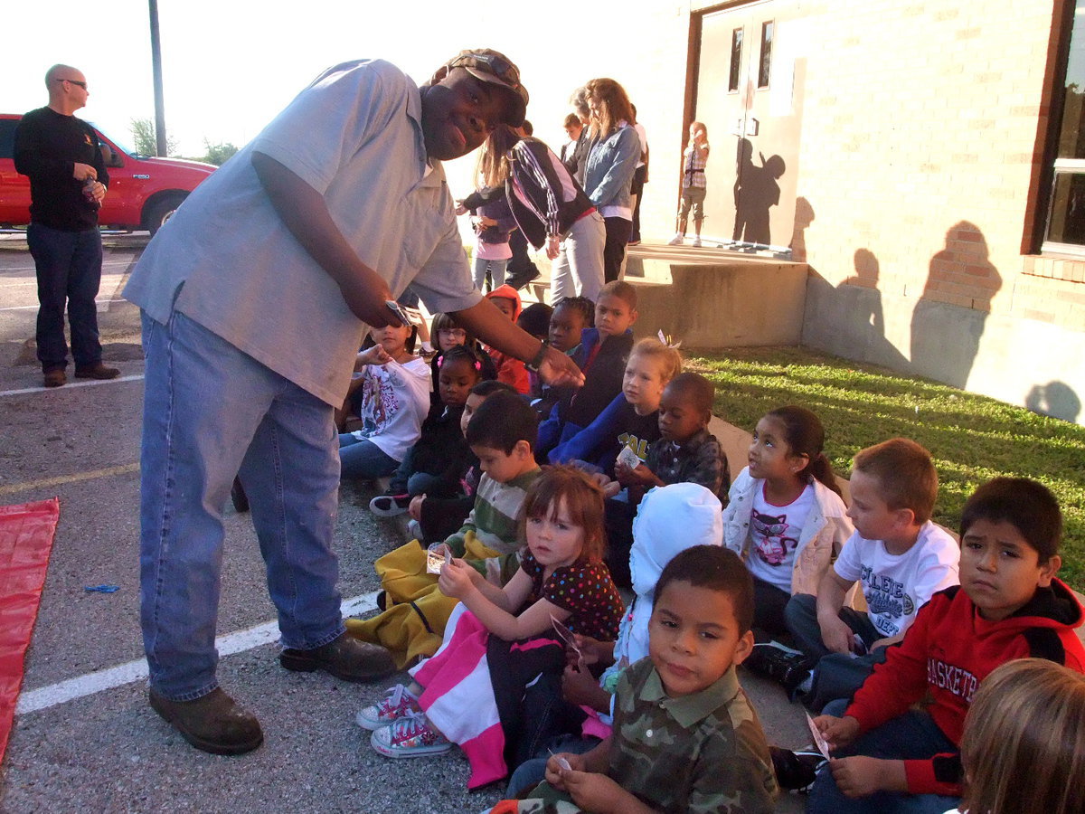 Image: Who Wants a Sticker? — Italy Fireman hands out badge stickers to all of the students.