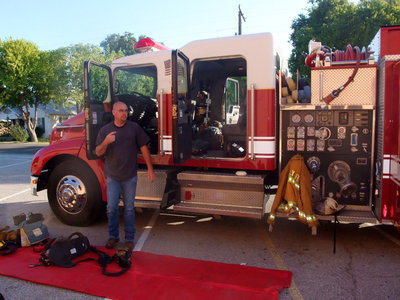 Image: Fireman Brad Chambers — Fireman Brad Chambers was explaining about the gear firemen wear to protect themselves from smoke and fire.