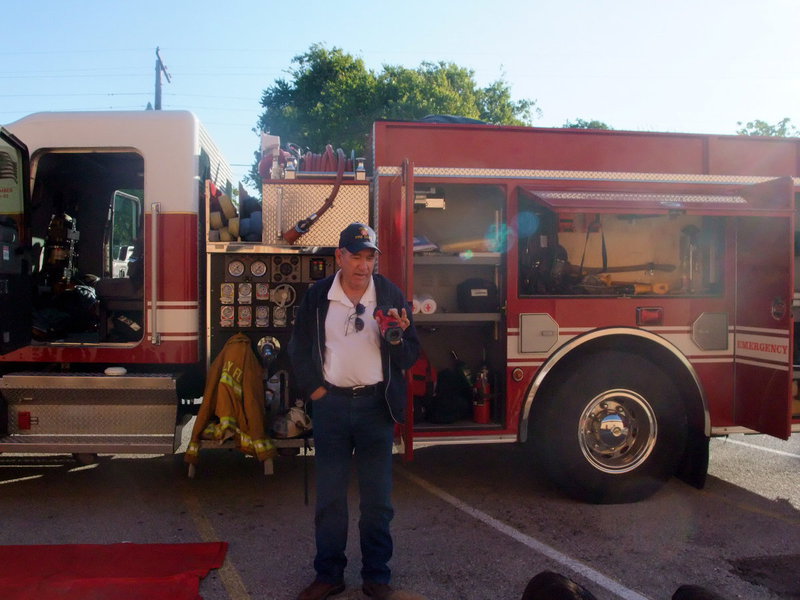 Image: Chief Chambers with Camera — Fire Chief Don Chambers was showing the students a camera that can detect smoke inside walls.