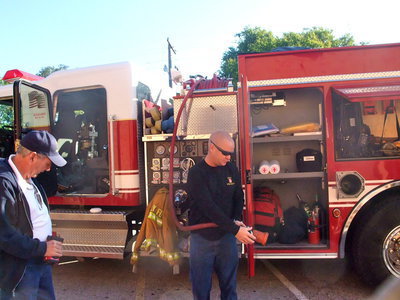 Image: Captain Michael Chambers — Captain Michael Chambers showing the fire hose and how it works.