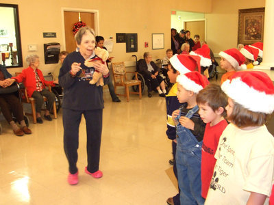 Image: Trinity Mission Resident — Trinity Mission resident directing the singing students!