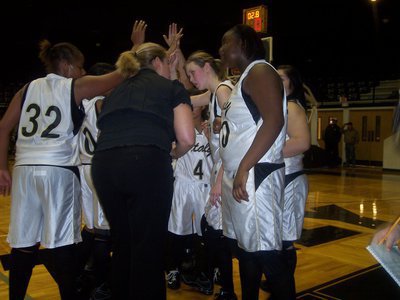 Image: Excitement In The Huddle  — Head Basketball Coach Stacy McDonald huddles with her squad after Megan Richards hit a jumper with 2.8 seconds left in the game to give Italy a win and a place in the Italy Invitational Tournament Championship. Italy won the second round game 35-31 and will play for the championship Saturday, December 6th at 6:00 p.m.