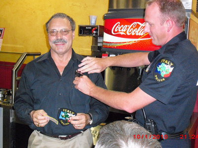 Image: Frank Being Badged — Lt. David Gray of the Italy Police Department gives Frank a badge.