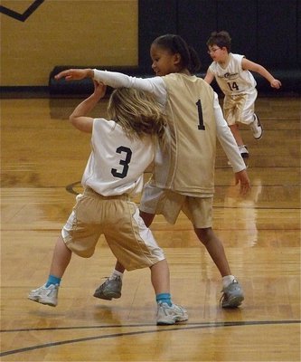 Image: Abby fights thru — Little Abby Evans(3) decides to lift the arm of Destiny Harris(1) and sneak under.