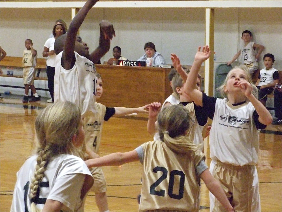 Image: Davis from distance — Jaylon Davis(12) puts up a shot as Alex Jones(15), Jacee Coffman(20), Lacy Mott, Reese Janek(14) and Bryce DeBorde(4) move in for the rebound.