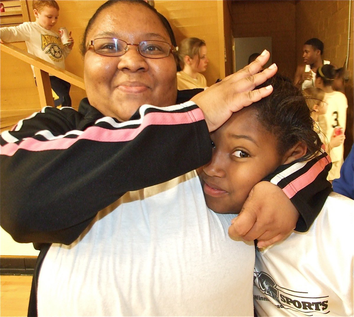 Image: Love pat… — Coach Olympia Williams gives Moesha Griffin a hug after the game…sort of.