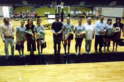 Image: Senior and parents — Lindsey Brogden and parents, Randy and Laura; Annalee Lyons (mom, Meg, was announcing); Becca DeMoss and stepdad, Tommy Sutherland; Angelica “Jelly” Garza and mom, Cherilyn Davis; Blanca Figueroa with parents, Javier and Blanca.  Everyone received yellow roses draped with their name and number and a picture of the team.