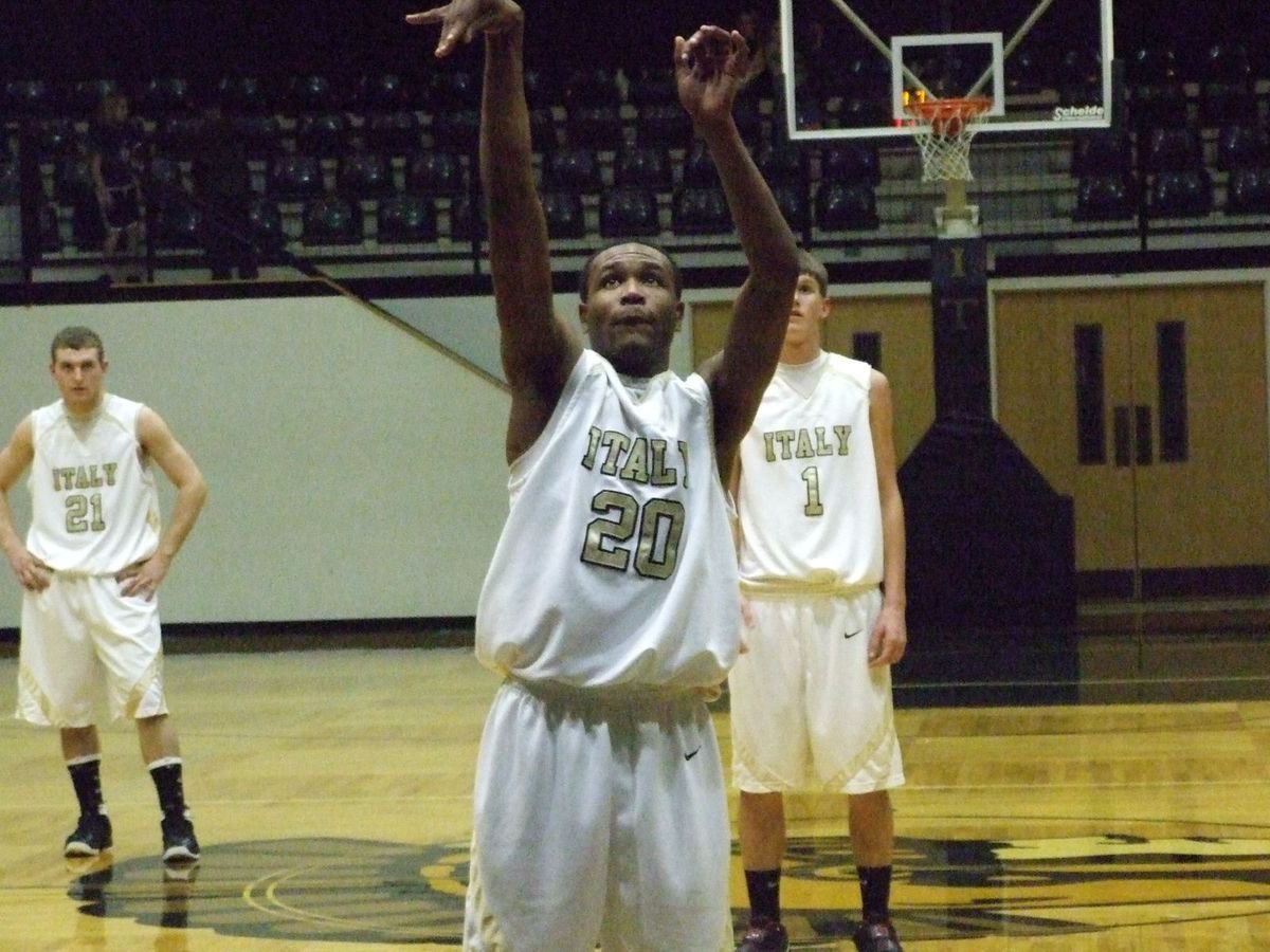 Image: Point made — Gladiators Kyle Wilkins(21) and Jase Holden(1) watch De’Andre Sephus(20) sink a free throw.