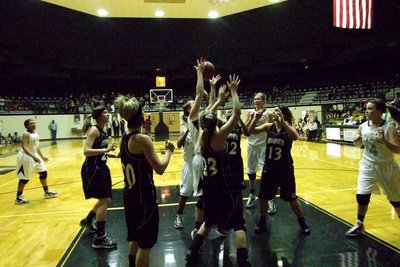 Image: Bailey working hard — Lady Gladiator Bailey Bumpus(13) tries to secure a rebound amongst a pack of Lady Zebras.