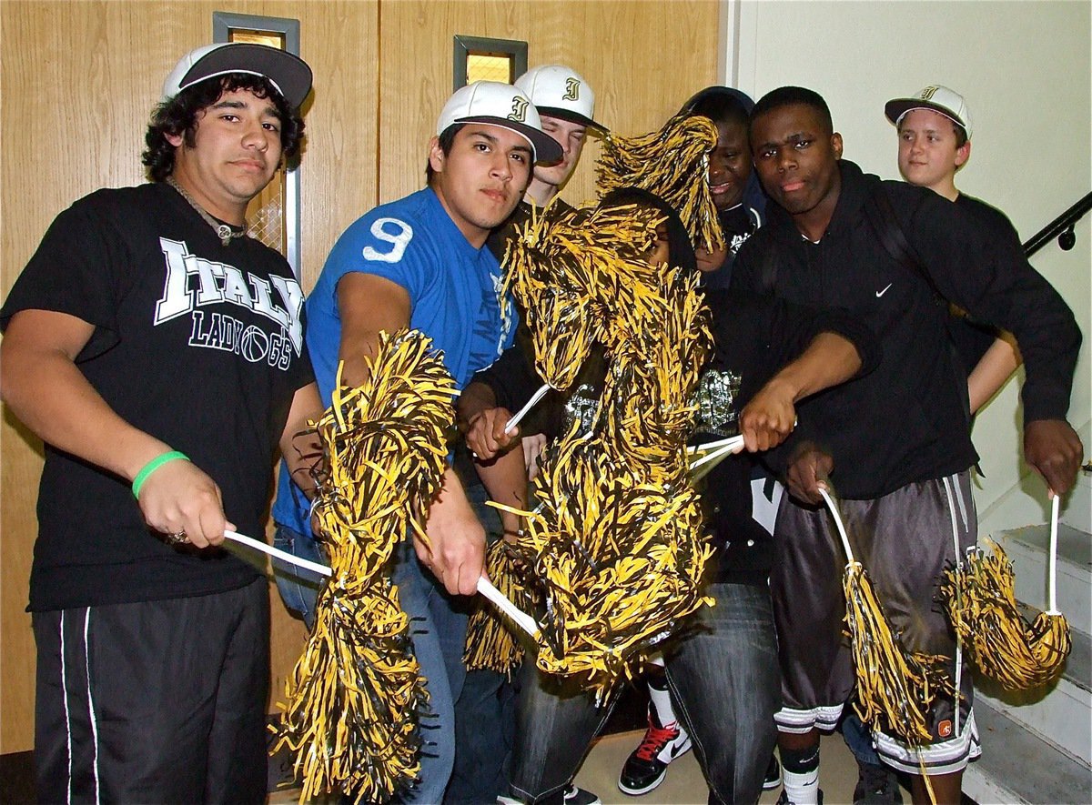 Image: Fans get involved — Michael Martinez, Omar Estrada, Chase Hamilton, Mike Clark, Adrian Reed, T.J. Cockran and Bailey Walton shake their pom-poms in support of the Gladiators and Lady Gladiators during Pack The Dome Night.