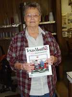 Image: Doris Mitchell — Doris Mitchell holding the coveted Texas Monthly declaring her restaurant to be one of the top forty cafes in Texas.