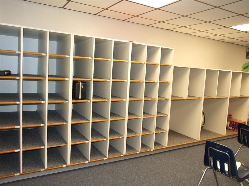 Image: The cubbie holes are bare.  — Each day the 6th grade band class convenes, empty cubbie holes serve as a constant reminder that they desperately need instruments. The first question asked by students is, “When are we getting instruments?”