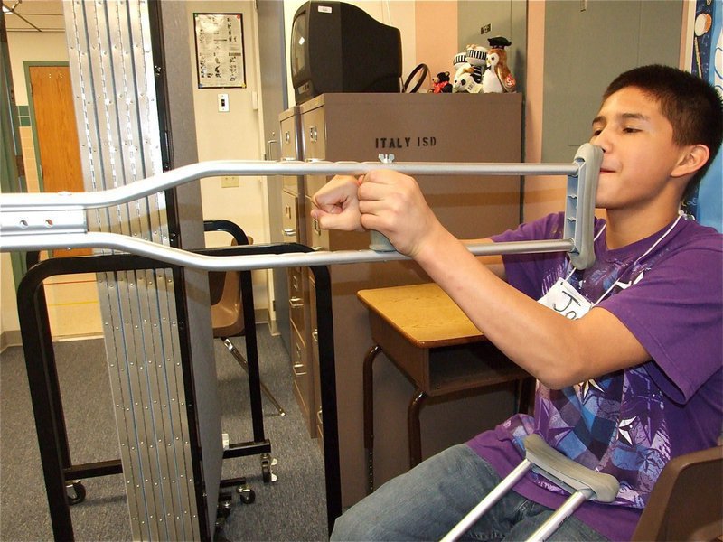 Image: Joe can dream — With the 6th grade band lacking enough instruments, Joe makes do and uses a crutch for a trombone.