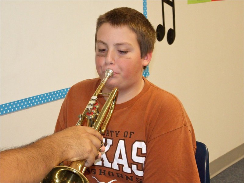 Image: Austin has skills — Austin tries out on the trumpet.
