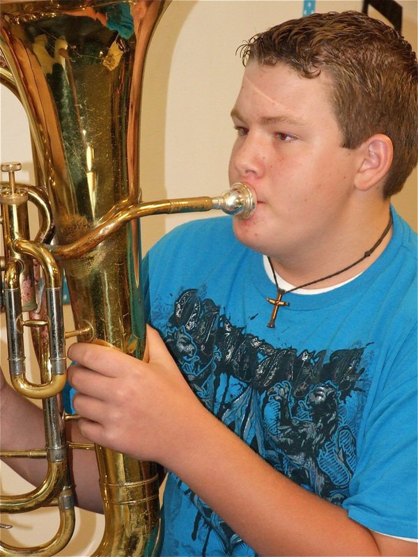 Image: This little thing? — Hunter is born to play in the band and hopes the community can hunt down extra instruments for the 6th grade band to use.