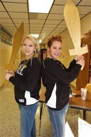 Image: Buy a burger… — How would you like your burger sliced? Lady Gladiators Megan Richards and Bailey Bumpus make a great sales force.