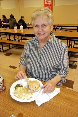 Image: Annette has a burger — Annette Hooser, grandmother of Lady Gladiator softball player Anna Viers, enjoys her burger for the cause.