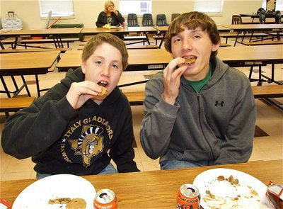 Image: It’s for the team — John Escamilla and Chace McGinnis enjoy their chocolate chip cookies after devouring their burgers. Just another example of how Lady Gladiator fans are willing to sacrifice for the team.