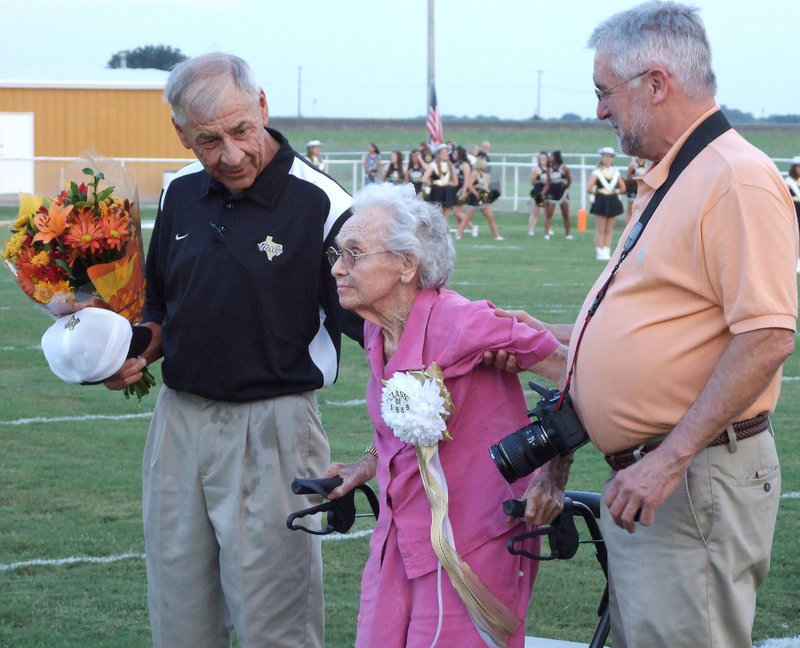 Image: Cinderella for the evening — Superintendent Jimmie Malone honors Mrs. Bryant with a bouquet of flowers and her class ring.