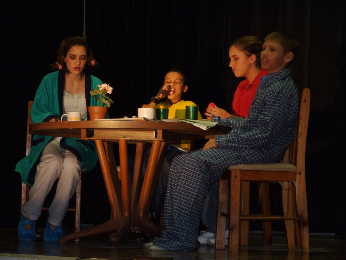 Image: Family eating breakfast — Rachel Strange – Mom, Jaquay Brown-Junior, Megan Price – Ann and Eric Evans – Oscar, all eating breakfast.