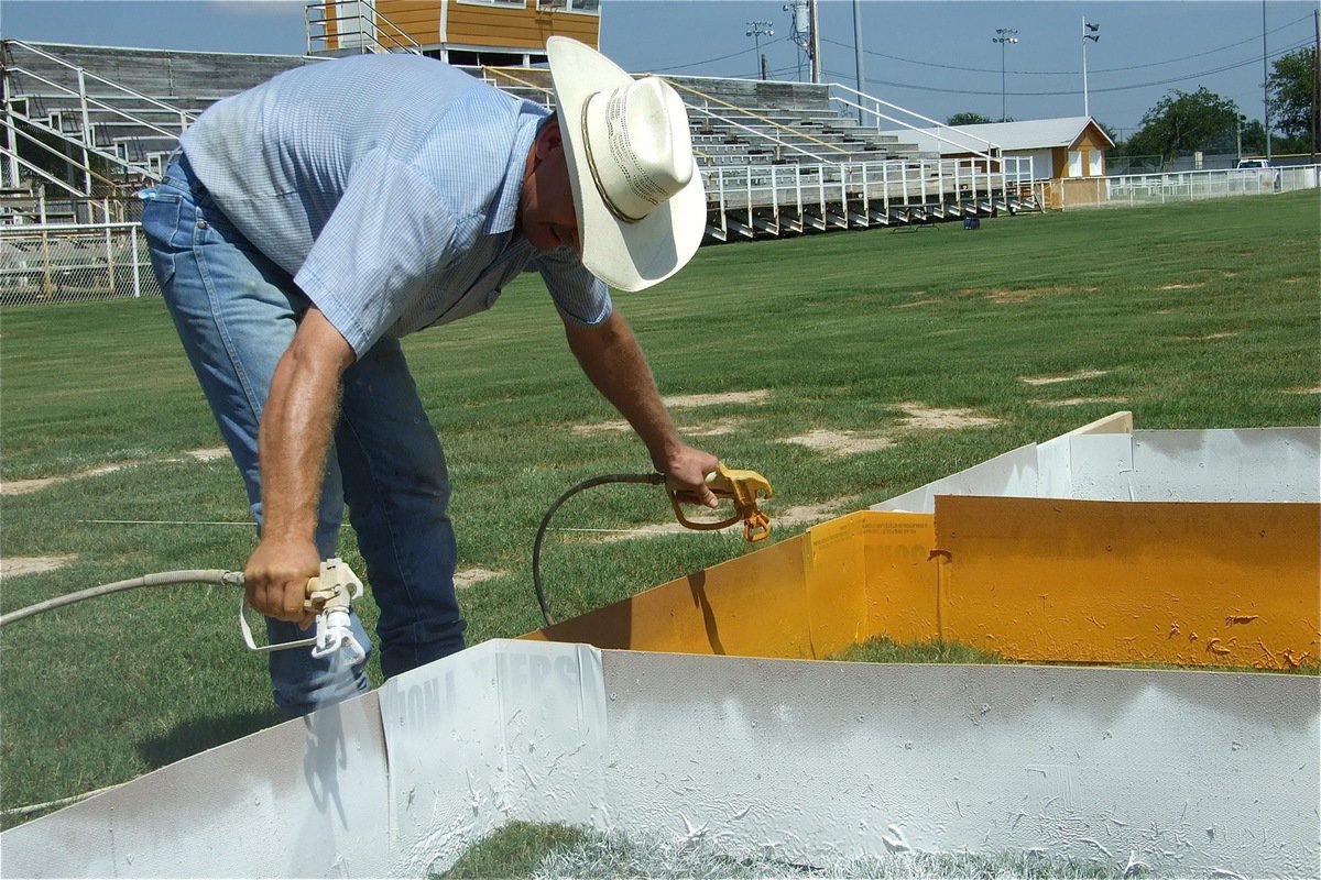 Image: Warning! — Do not attempt this trick in you own endzone! Since four board members would qualify as a quorum, Curtis Riddle uses both hands to make up the difference.