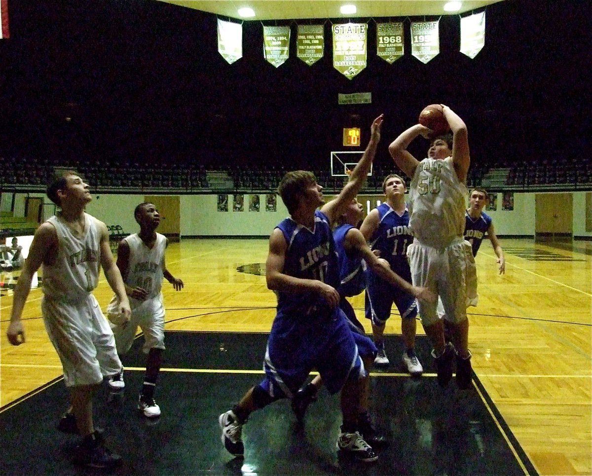 Image: The big guns — Zain Byers(50) tanks his way into the paint for a shot at the basket.