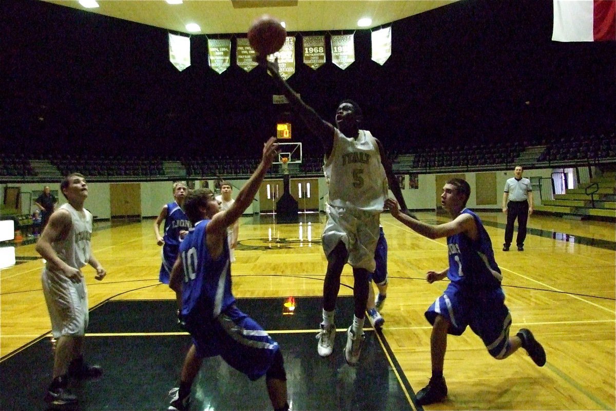 Image: Piercing shot — Italy finger rolls in a hoop over Blooming Grove as Haden Woods(1) stands at the ready to rebound.