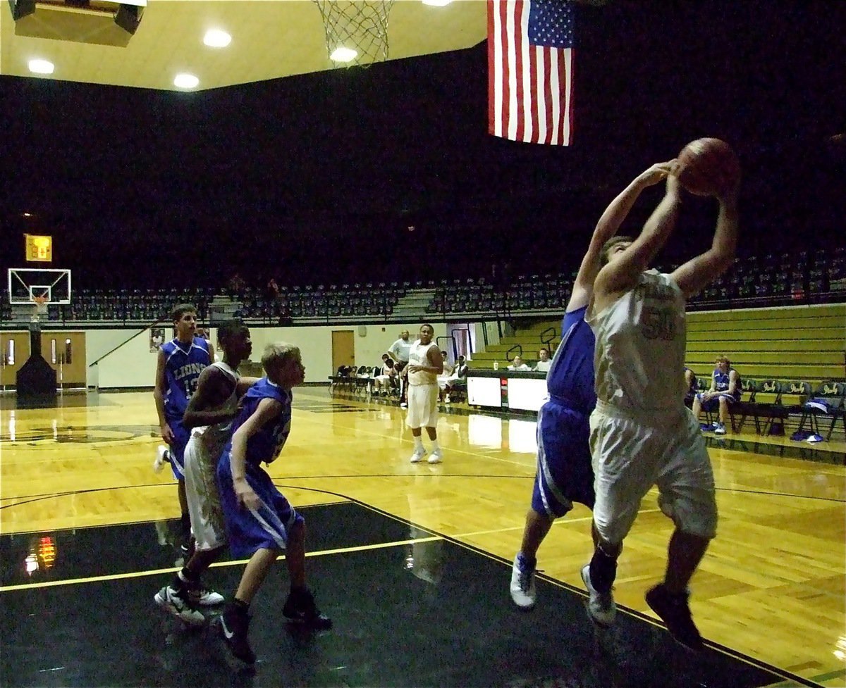 Image: Sneak attack — Italy’s Zain Byers(50) sneaks in for an offensive rebound to keep the possession alive for the JV Gladiators.