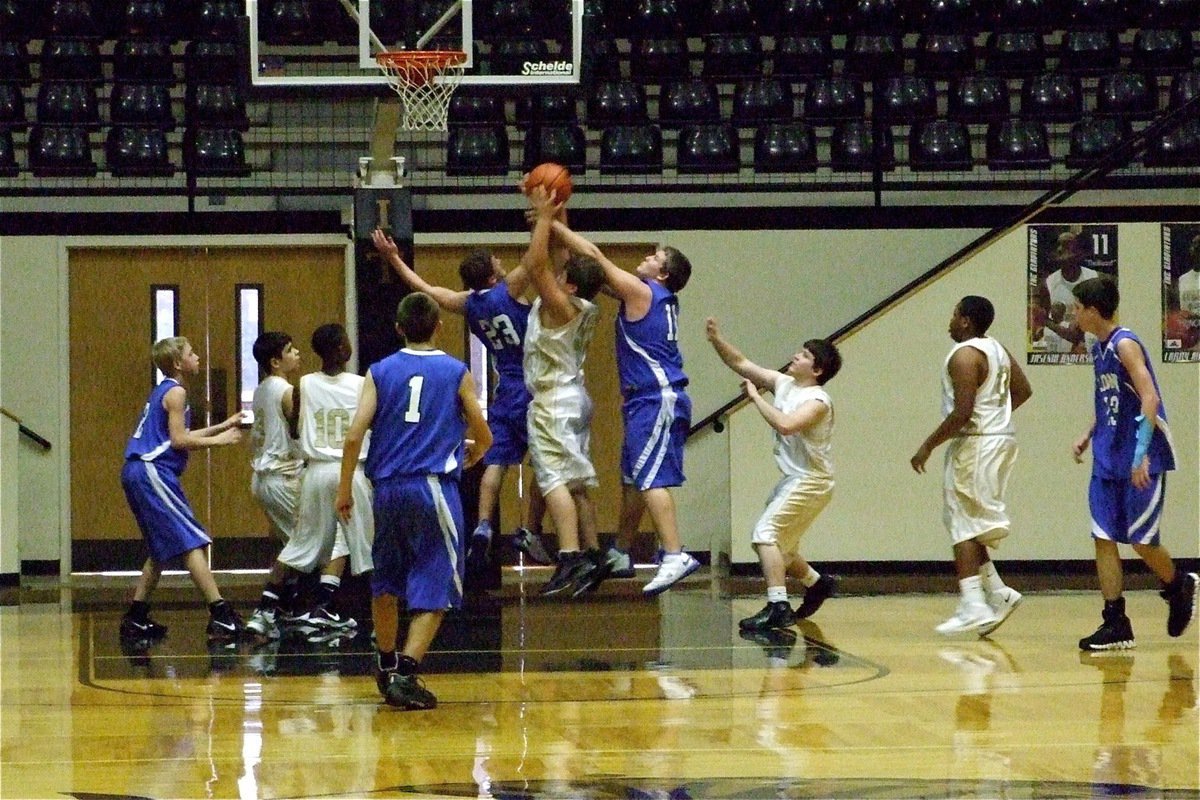 Image: Big-time rebound — To the amazement of his father, Zain Byers(50) rips the ball away from a couple of Lions.