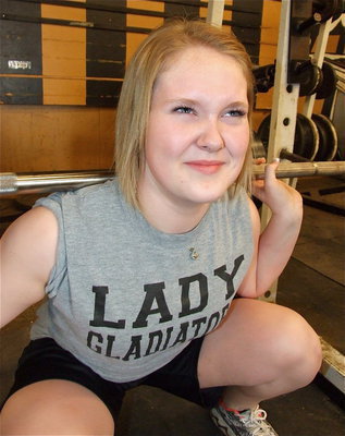 Image: Jessica Wilkins — Jessica does her squat lifts during the team’s workout.