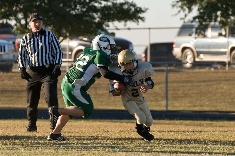 Image: Going For It — 2 – Tylan Wallace attempts to escape the claws of Scurry Rosser Wildcat.