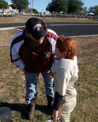 Image: Dad Lends Advice — Levi Stark intently listens to his father and former football player Charlie Stark at halftime.