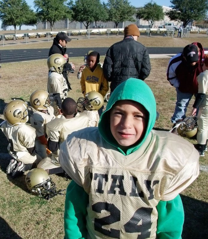 Image: Coach…I’m Cold! — Andrew Gomez is looking for some place warm at halftime as the players get replenished with oranges and grapes.