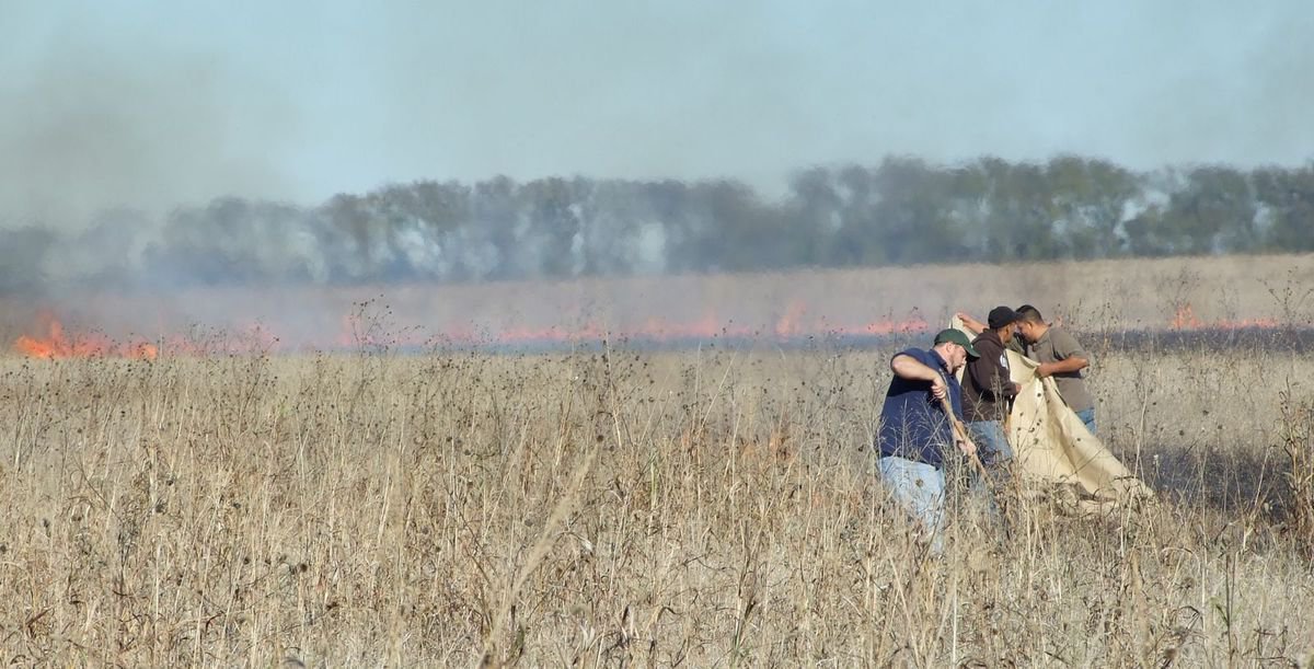 Image: People Use Shovels And Fabric — Workers at Monolithic used shovels and fabric to stop the fire from spreading.