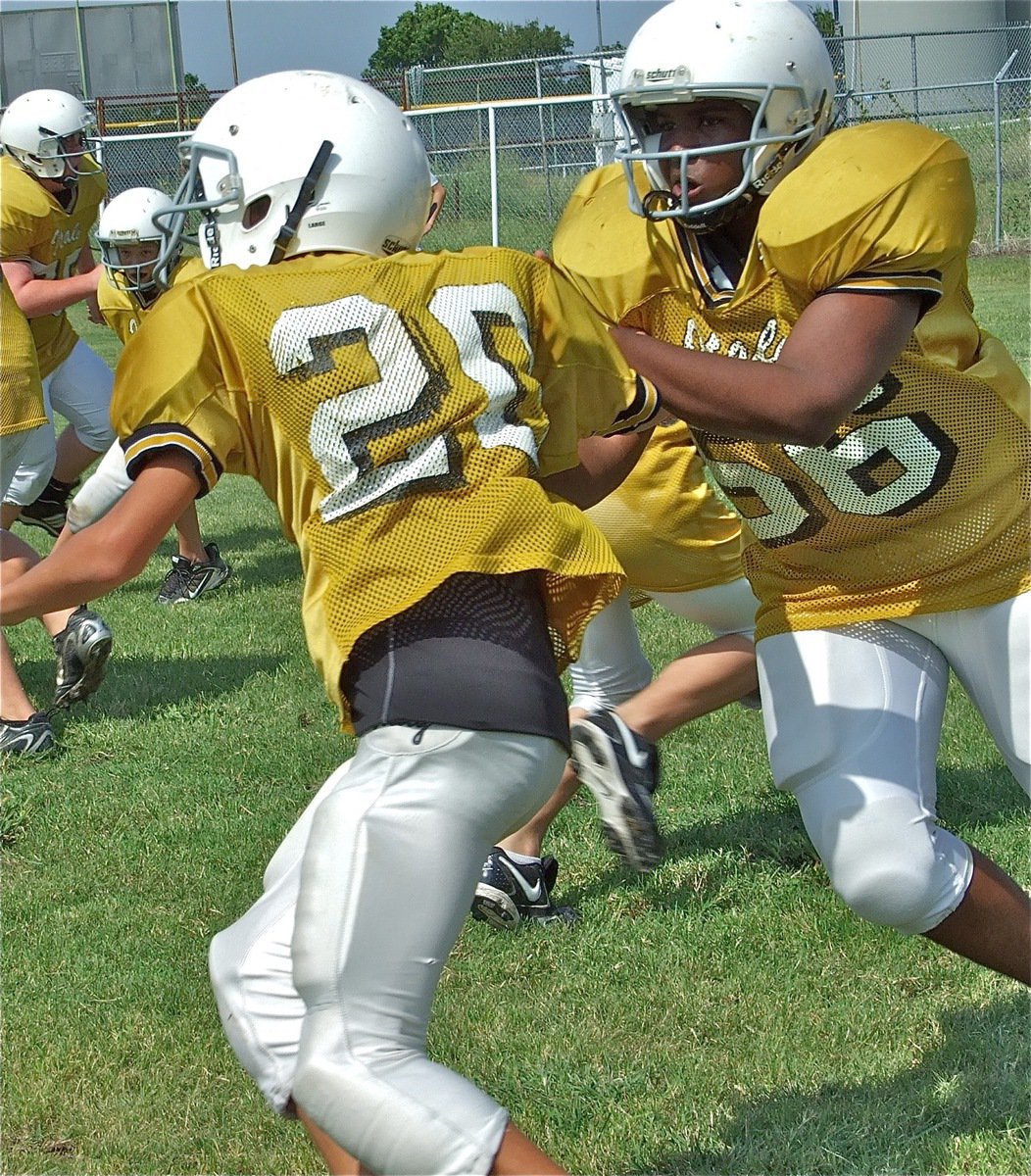 Image: Making room — The offensive line tries to make running room for the backfield.