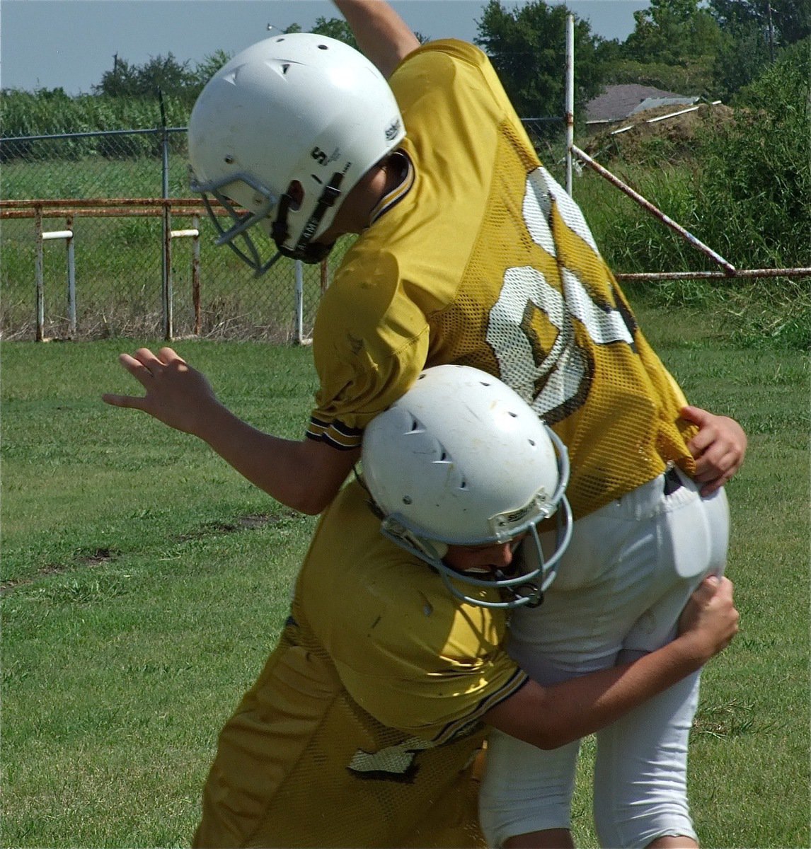 Image: Cousins collide — Brandon Connor gives his quarterbacking cousin Ryan Connor a love tap.