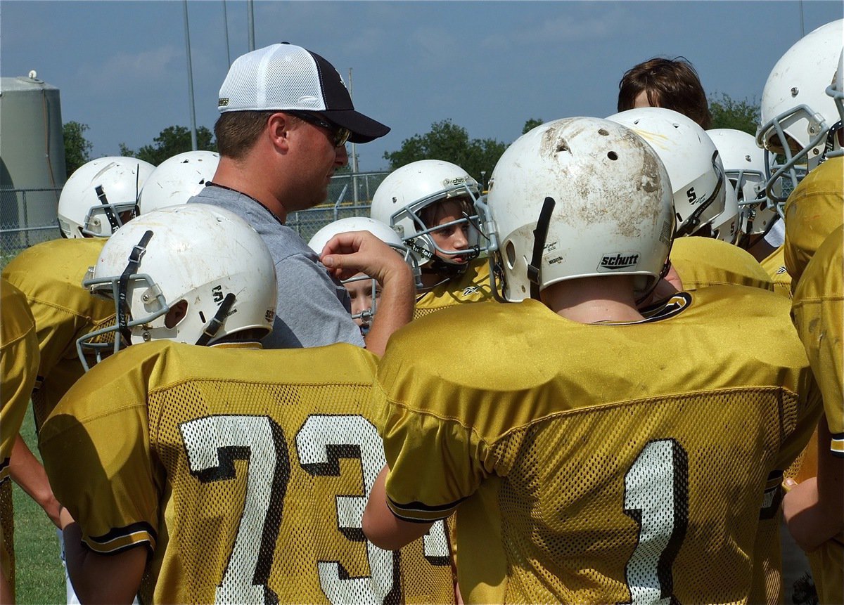 Image: Huddle on me! — Coach Josh Ward talks with the team after practice.