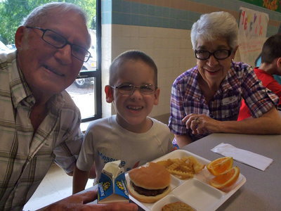Image: Linus, Kinley and Jackie — Kinley is enjoying his lunch with his grandparents Linus and Jackie Bullock.