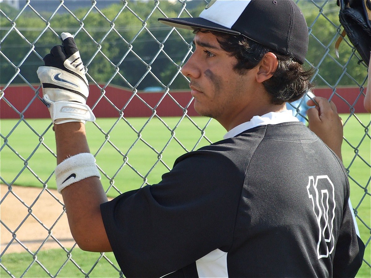 Image: Checking the comp — Michael “Taz” Martinez studies the game prior before Italy played their first of two games on Saturday.