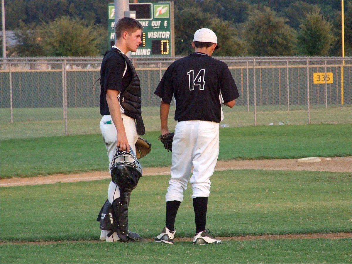 Image: What’s a Mud Dog? — Catcher Ryan Ashcraft checks on pitcher Karsen Minniear during the game.