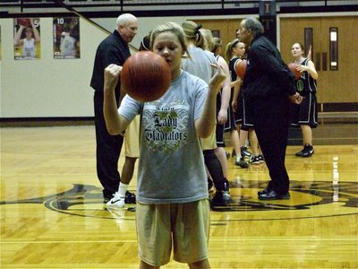 Image: A spin on things — Bailey Eubank practices her free-throw rhythm before the 8th grade game starts.