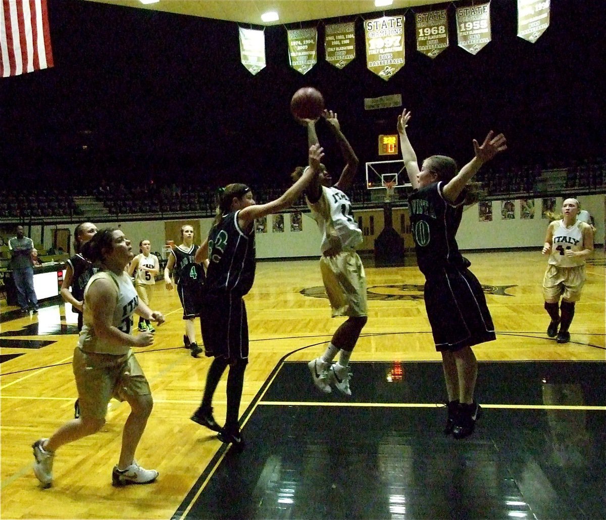 Image: Capes vs. wings — Kortnei Johnson(15) scores inside over a pair of Eagles.