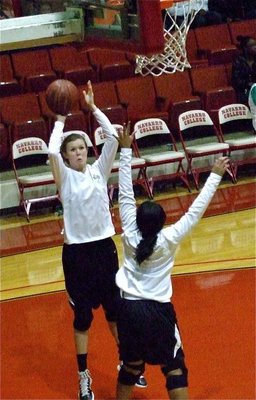 Image: Kyonne and Kaitlyn — Lady Gladiator Kyonne Birdsong pressures teammate Kaitlyn Rossa who takes a warmup jump shot before the Italy versus Kerens game in round one.