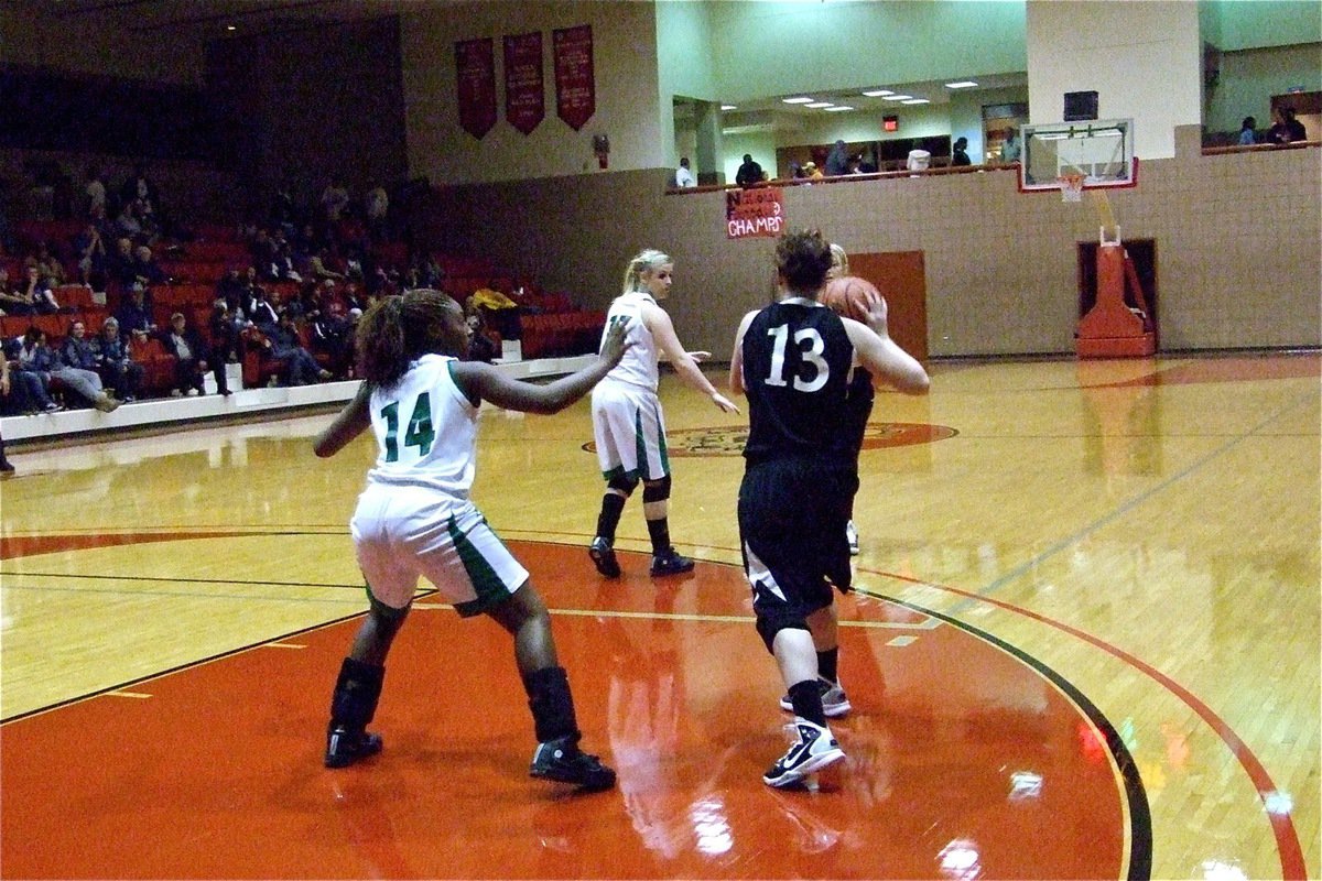 Image: Tight defense — Italy’s Bailey Bumpus (13) tries to swing the ball around the horn.