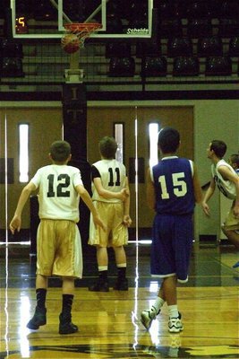 Image: Trick shot — John Escamilla(11) swishes a free-throw with one arm behind his back.