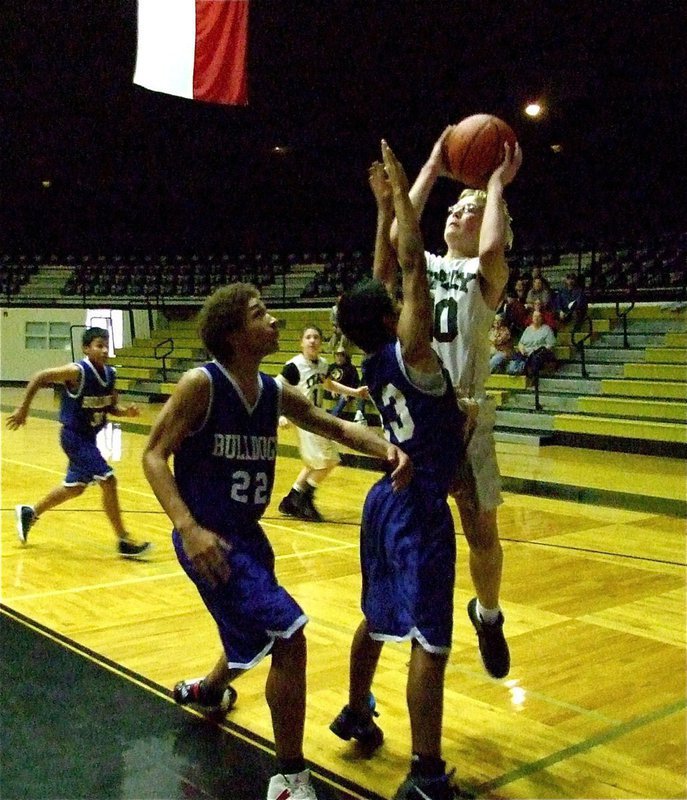 Image: More the merrier — Italy’s Cody Boyd(10) leaps along the baseline and takes a shot over two Venus’ defenders.