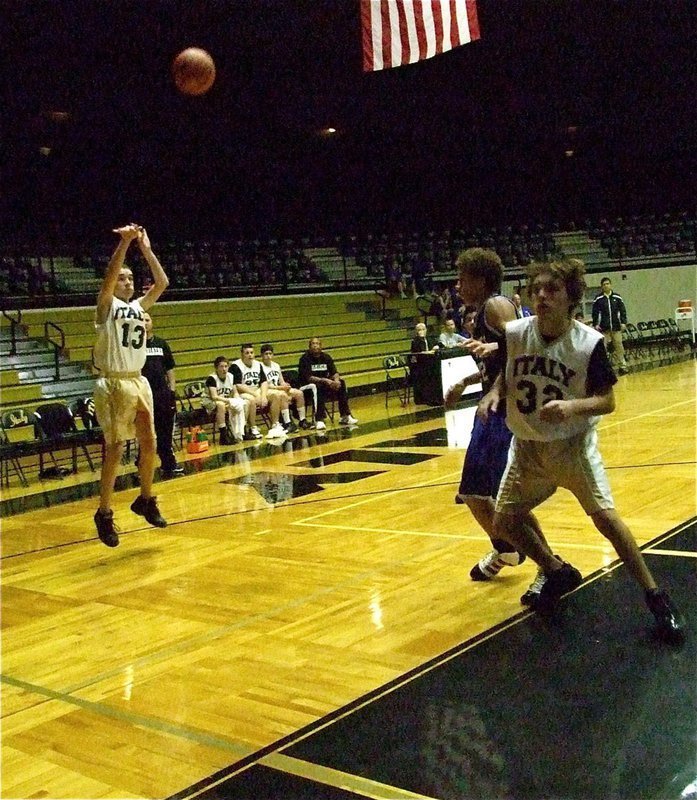 Image: Ryan shoots — Ryan Connor(13) takes a shot from the wing while teammate Chace McGinnis(32) fights for rebounding position.