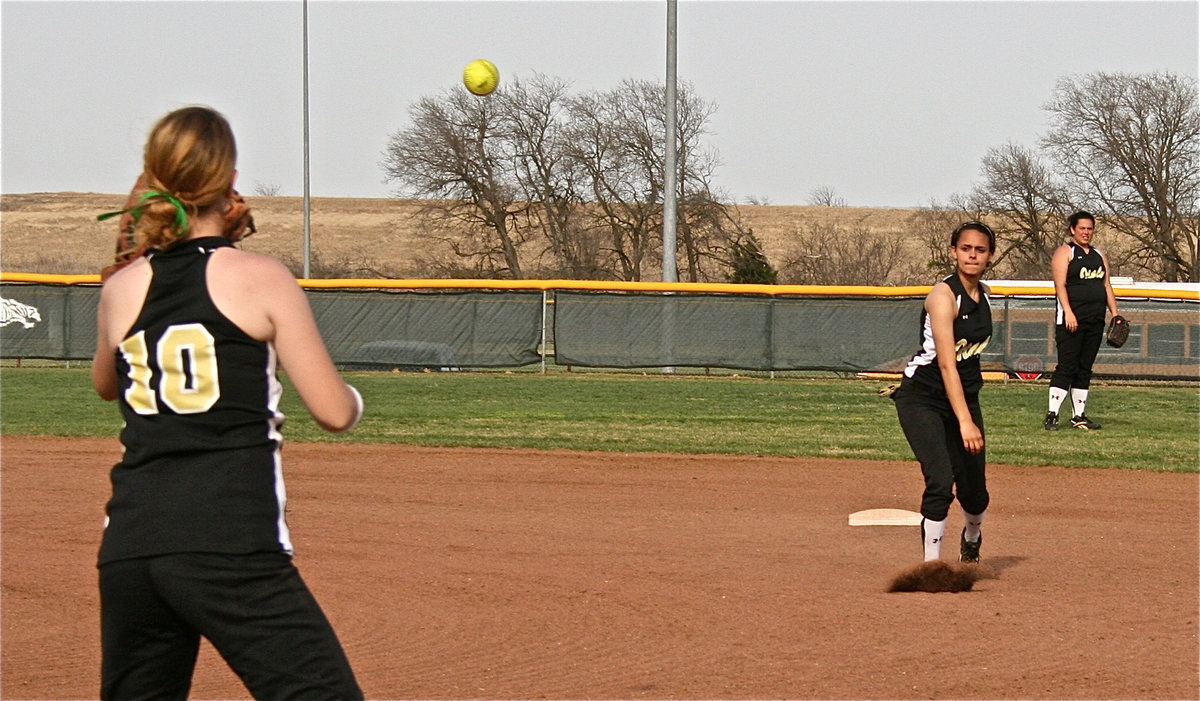 Image: Practice, practice! — Anna Viers warms up her throwing arm with Lady Gladiators’ first baseman Paige Westbrook.