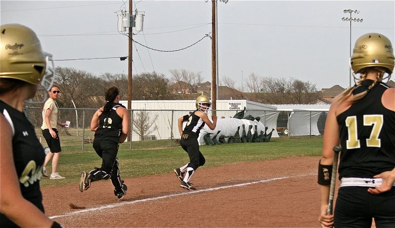 Image: Uh, oh! — The Richards’ sisters look on as Anna Viers(3) tries to turn a triple into a homer. Caught in a run down, Viers eventually gets tagged out before reaching third base. No worries, however, as head coach Jennifer Reeves and the team had a good laugh afterwards.